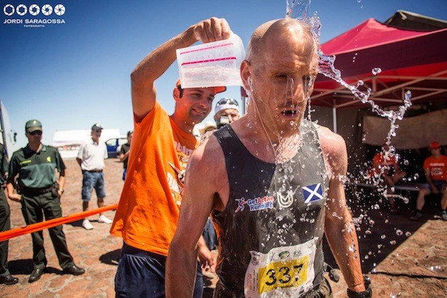 Voluntario refrescando a corredor de Transvulcania. Foto: Jordi Saragossa